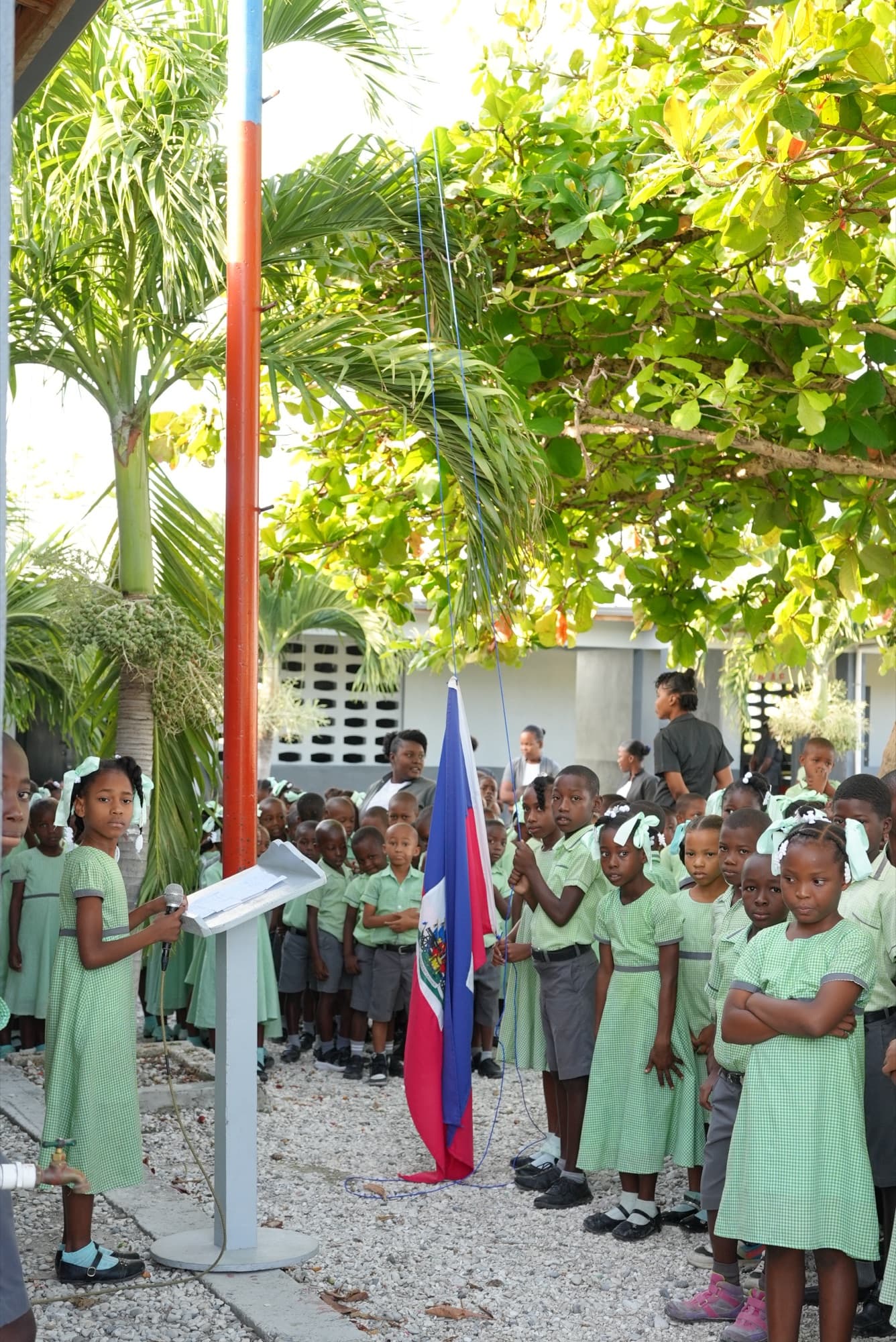 Schoolchildren in uniform at a flag ceremony in Haiti